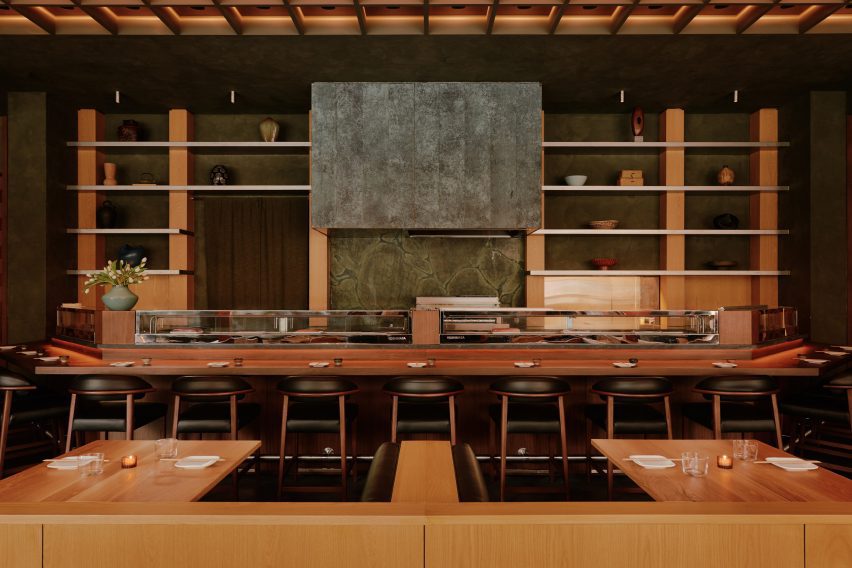 Mottled green plasterwork envelops a sushi counter