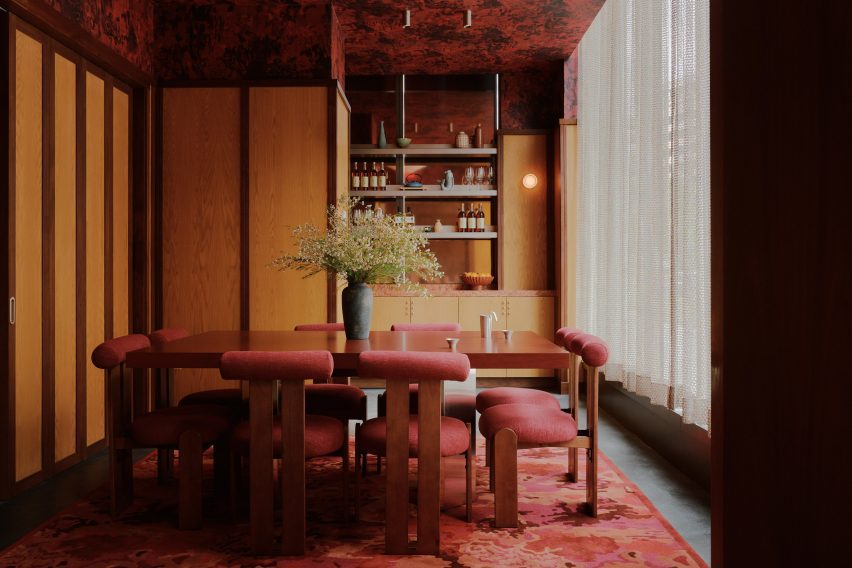 A private dining room featuring dark tones and rich colours
