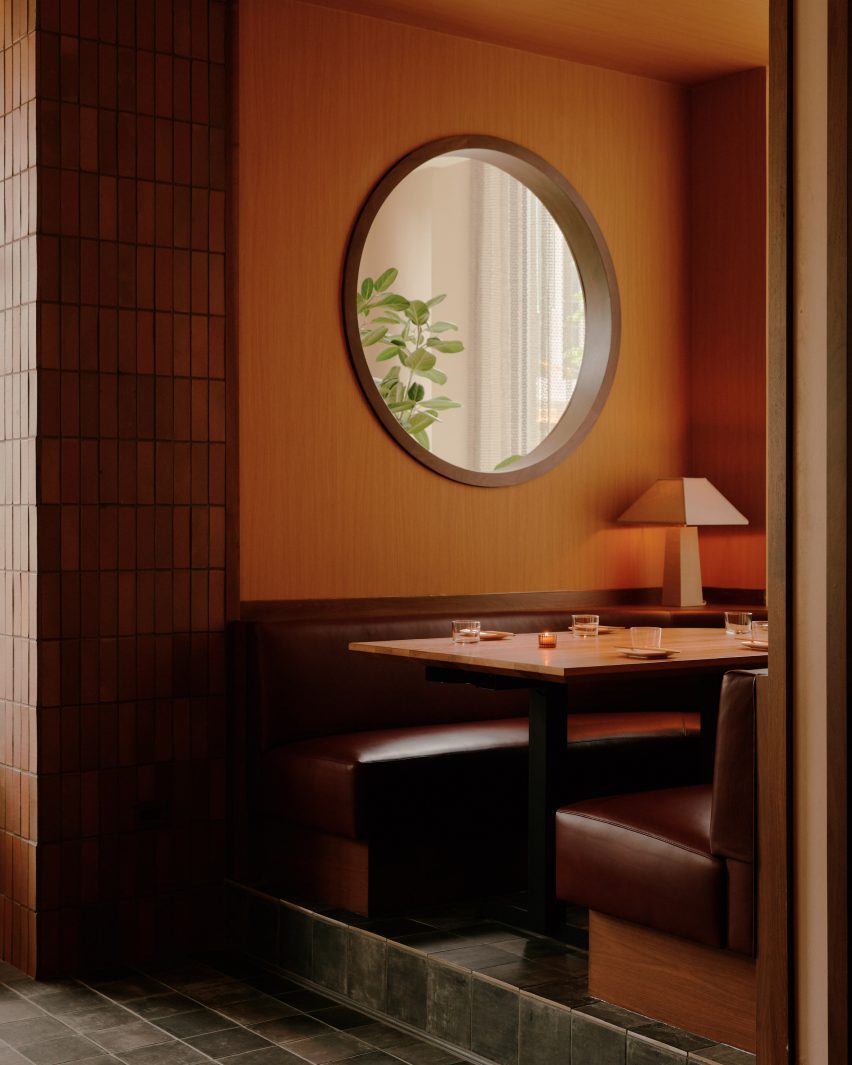 An intimate booth with a circular window
