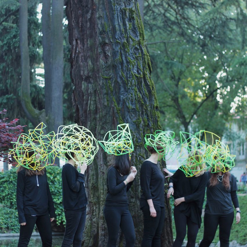 an image of people wearing green and yellow abstract headpieces