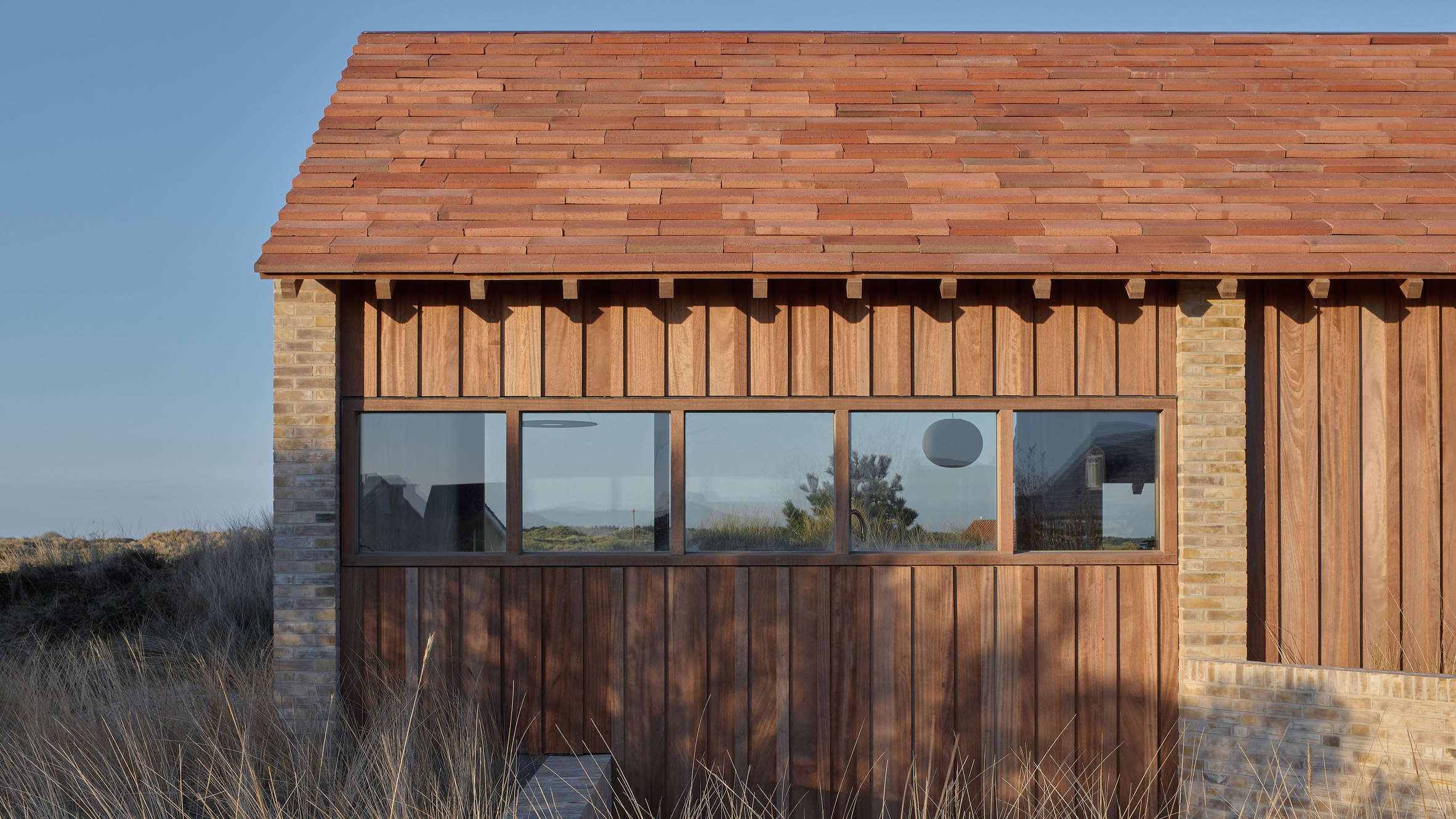 https://static.dezeen.com/uploads/2026/06/unknown-architects-house-on-a-dune-timber-cabin-netherlands-hero_dezeen_2364_col_1.jpg