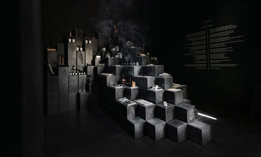 Black-cement blocks form a stepped display in a perfume showroom
