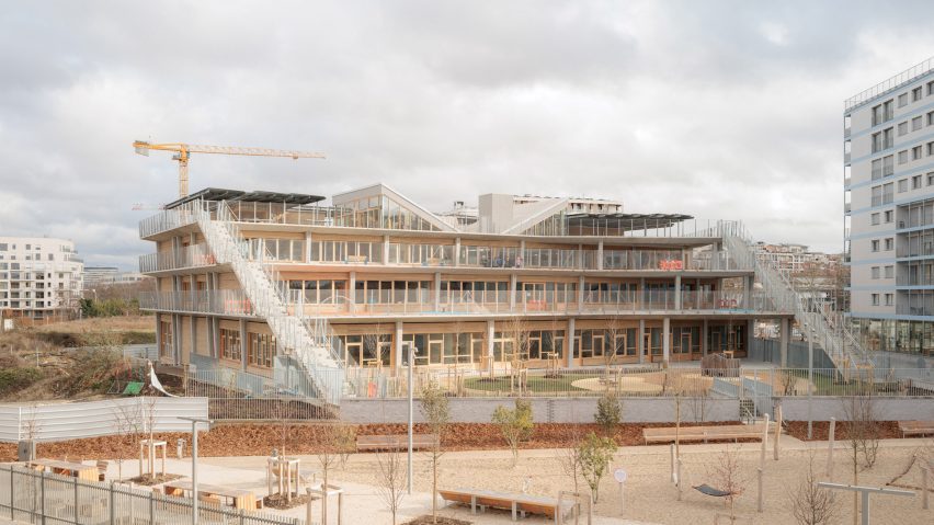 Exterior view of the stepped school building with cascading terraces and external staircases