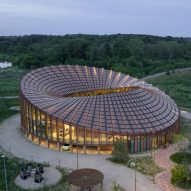 BIG arranges circular Dymak HQ around stepped courtyard