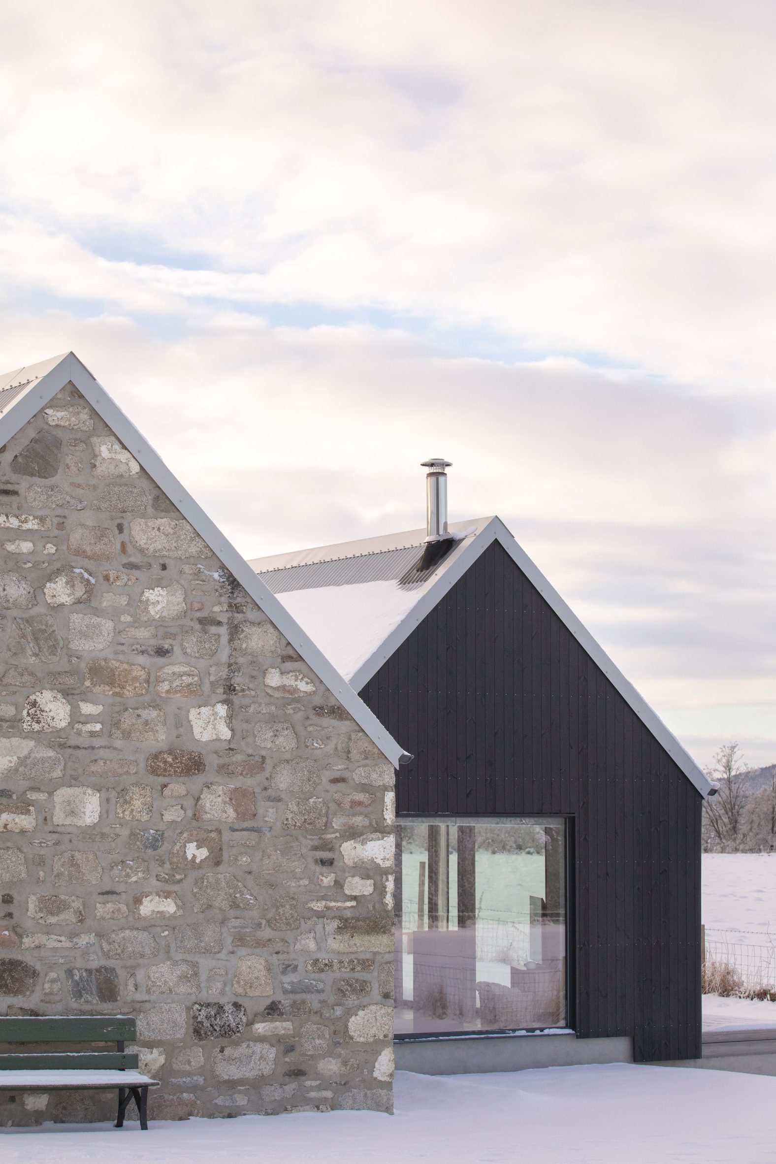 Close up of granite cottage connected to the blackened-larch extension