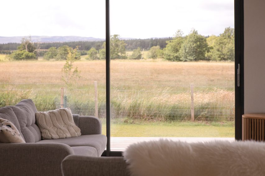 Living room with floor-to-ceiling glazing overlooking Dava Moor and the Highlands