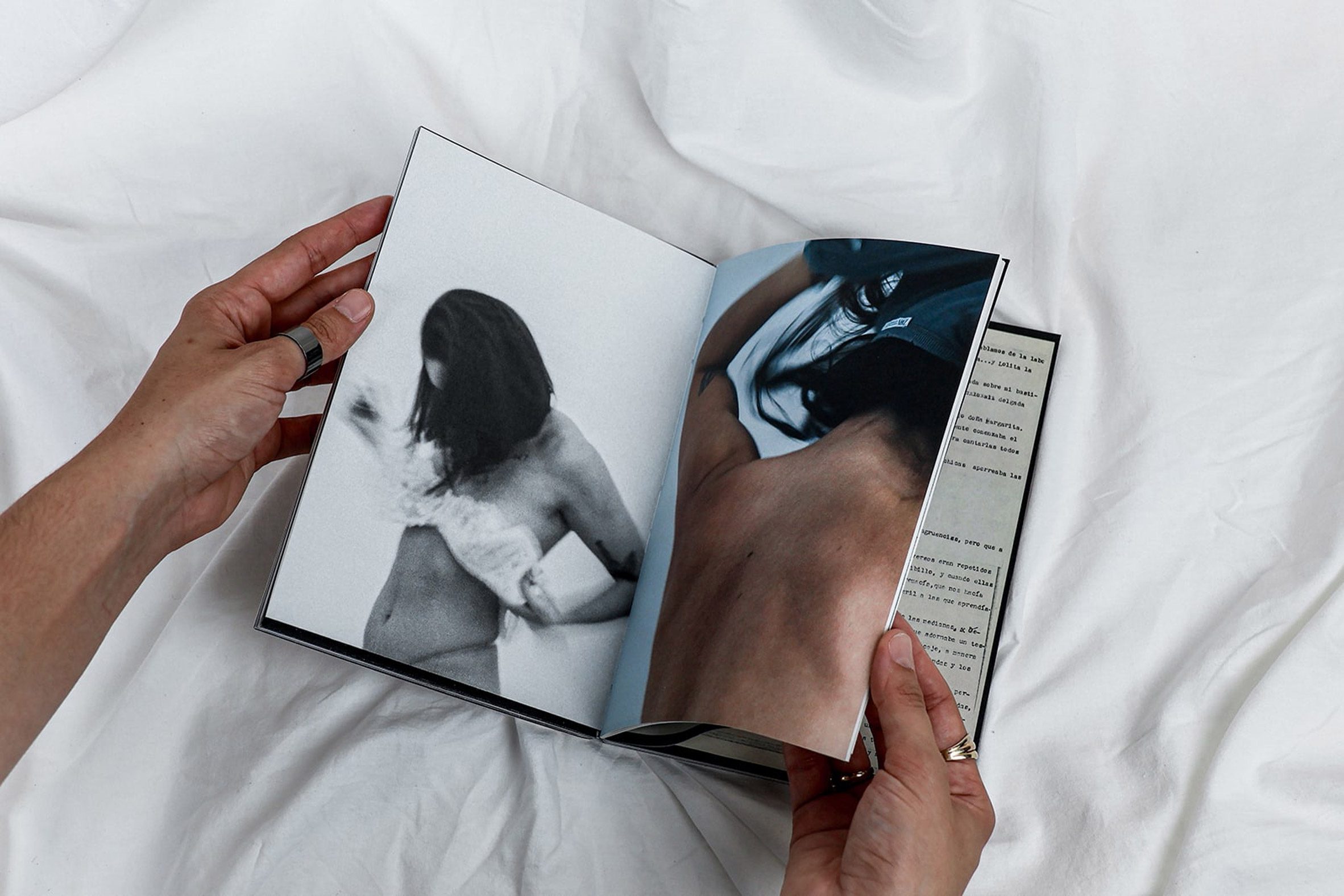 Hands flicking through a small book containing pictures of the people getting dressed/undressed