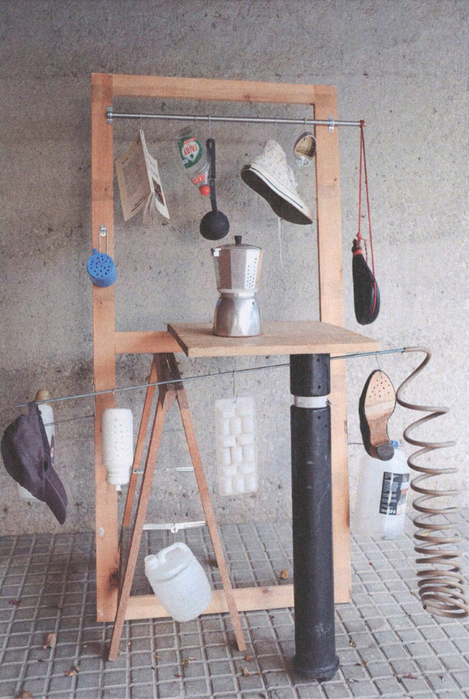 Sculptural structure with household items attached to it