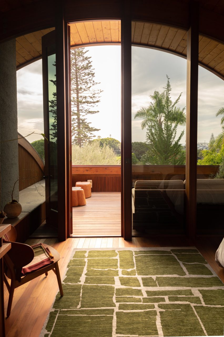 Large arched window with an open door overlooking a forest