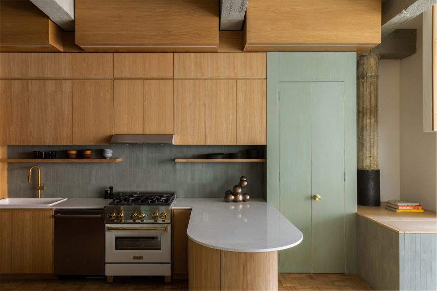 Tonal green accents incorporated in a kitchen to contrast oak cabinetry