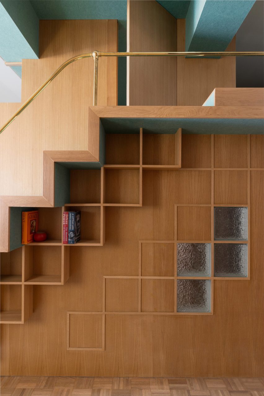 A mezzanine reading nook accessed via flight of felt-covered stairs