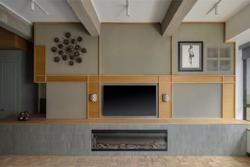 A large green-painted wall divides a living area from a primary suite
