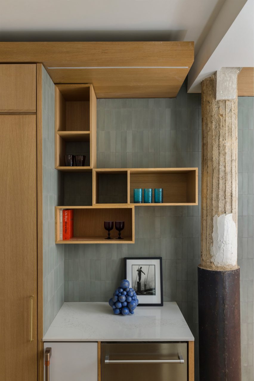 A factory building's original columns are incorporated into an apartment interior