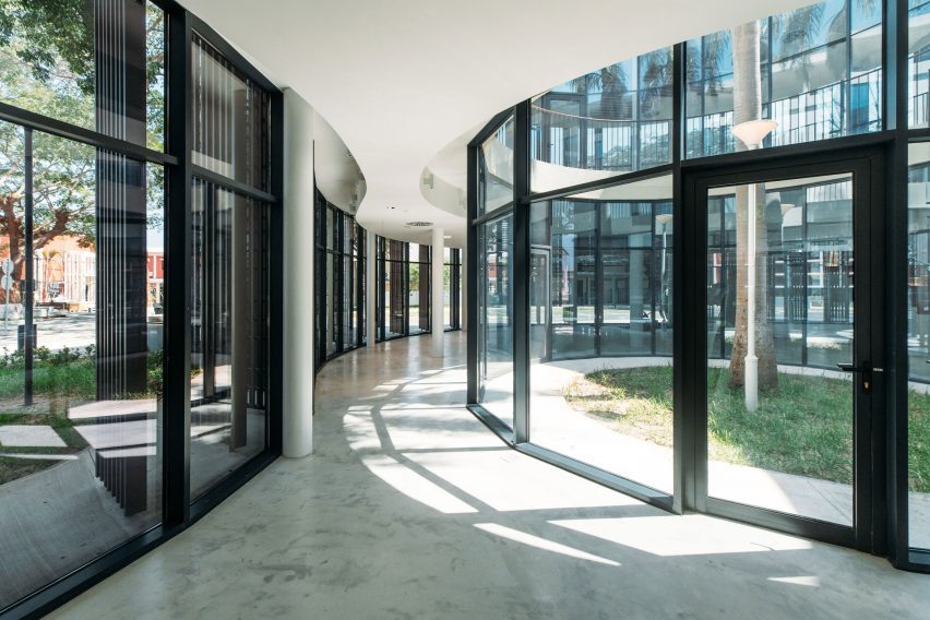 Interior view of the entrance level with curved glazing overlooking planted courtyards