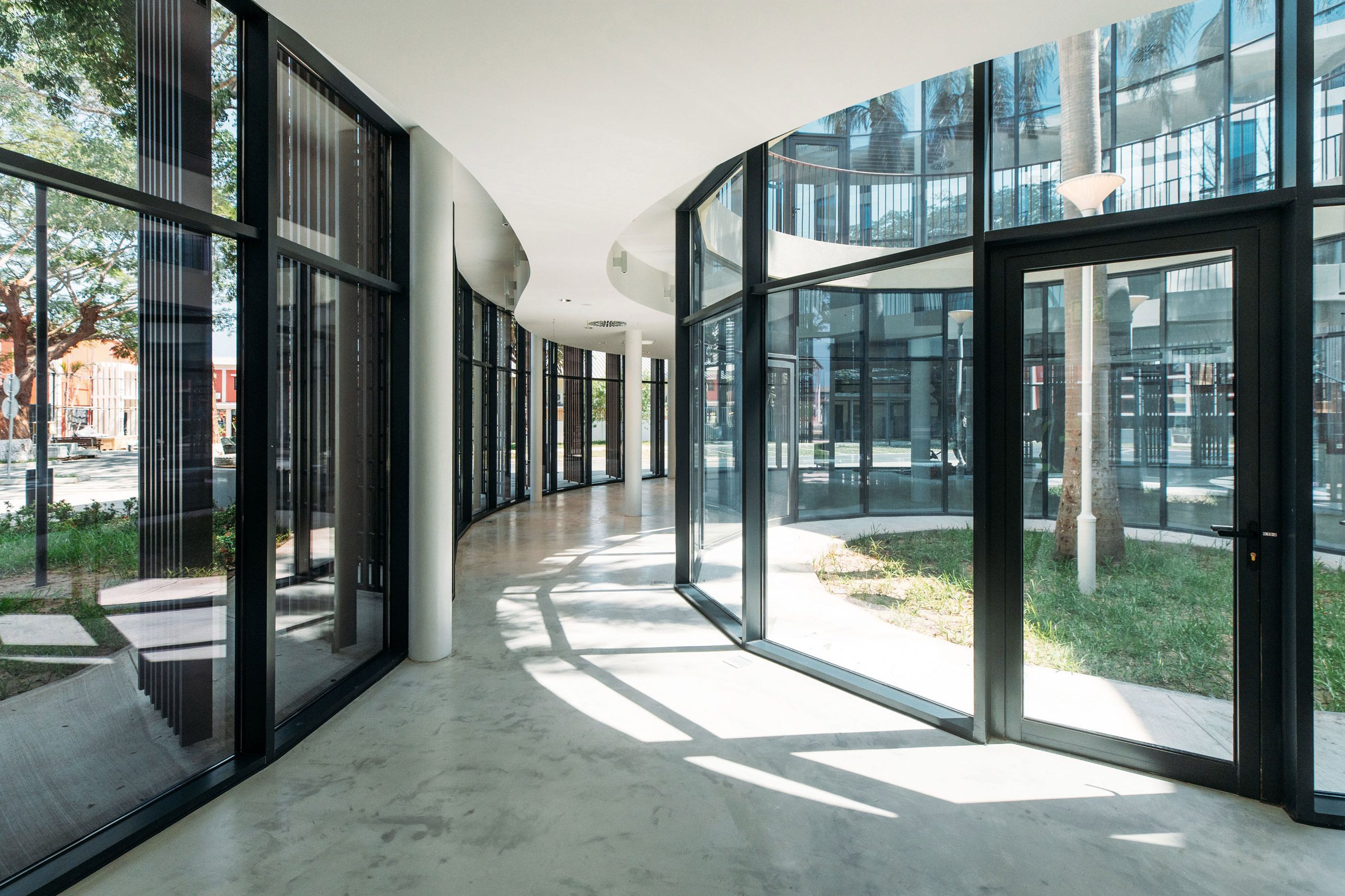 Interior view of the entrance level with curved glazing overlooking planted courtyards