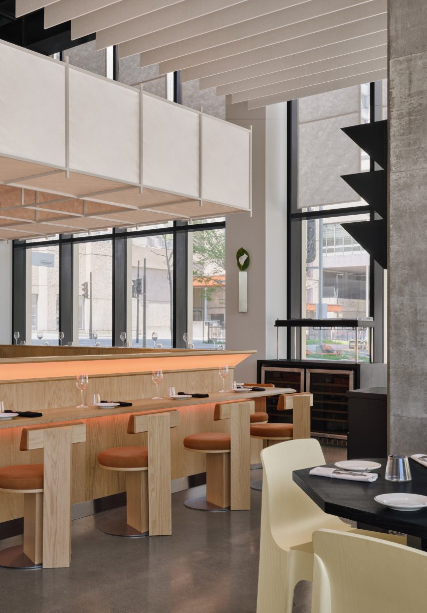 Restaurant interior with triangular shapes in the wall-mounted lighting and millwork details