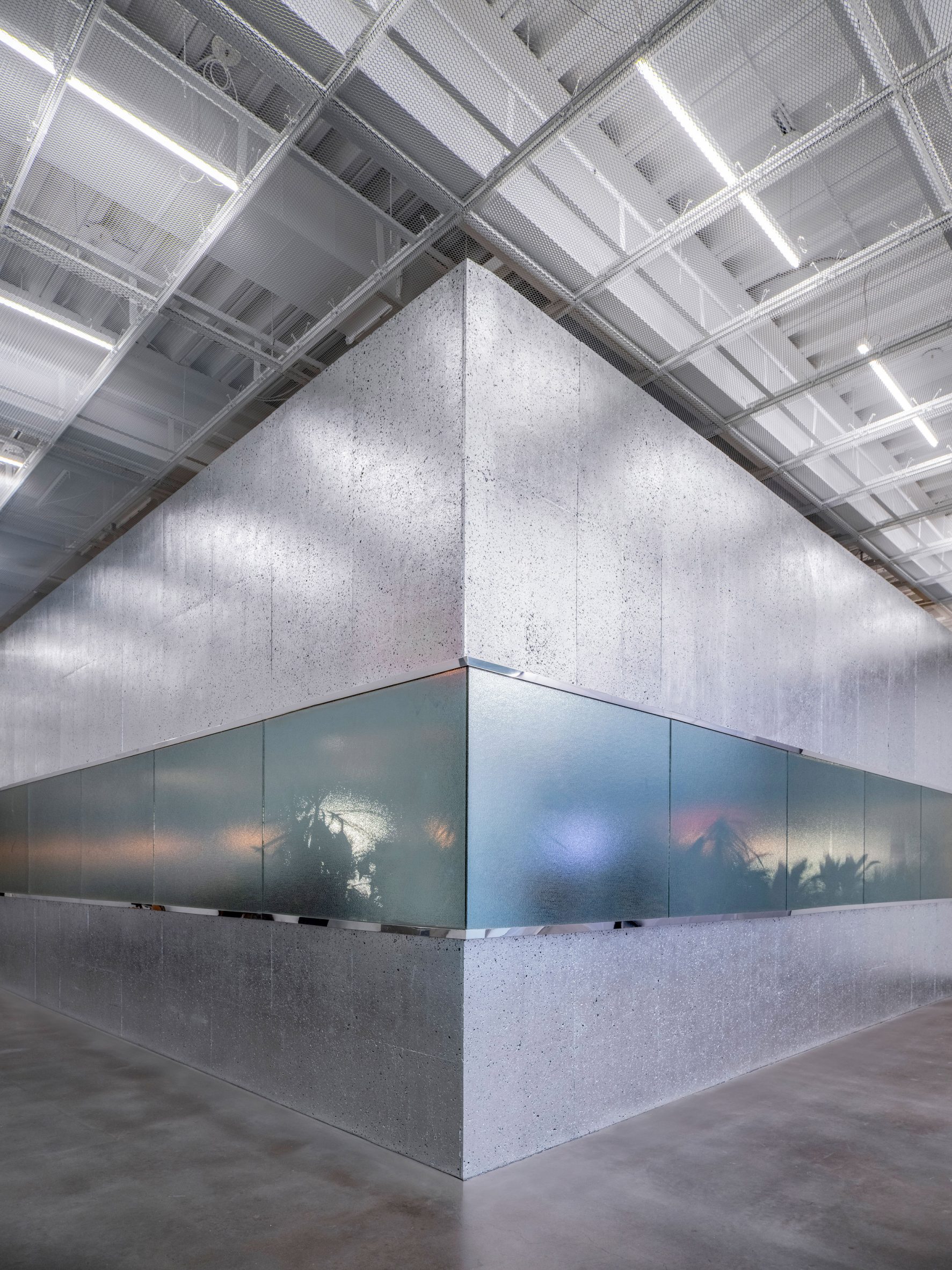 A horizontal band of frosted glass breaks up a metallic box-like exterior
