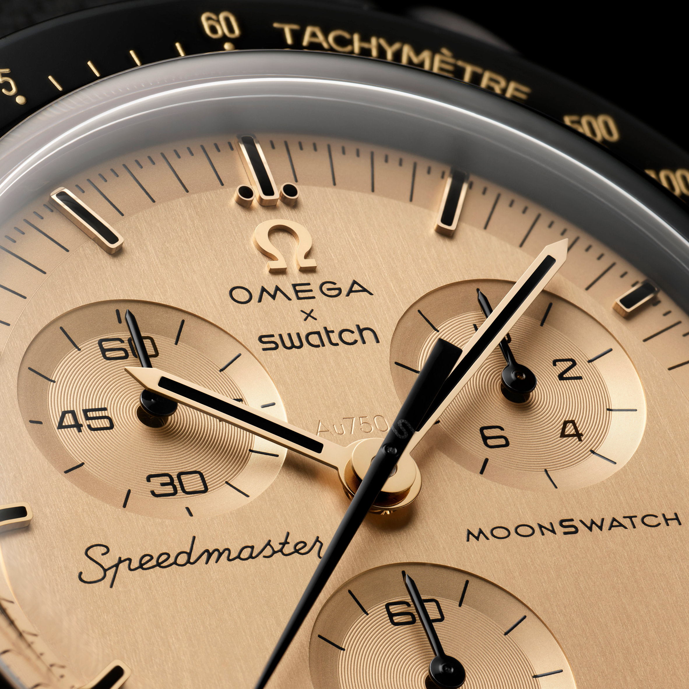 Close-up image of the gold MoonSwatch showing period-correct logos and typography and gold bevelled indexes finishes with black laquer