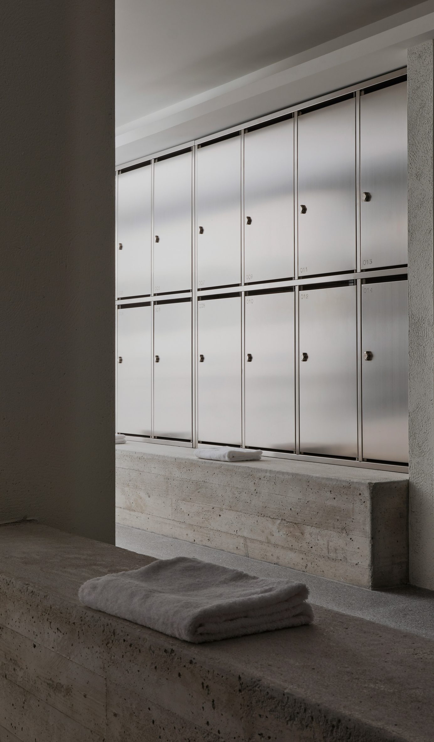 Concrete benches in factory changing rooms in San Sebastian by Ortega Diago