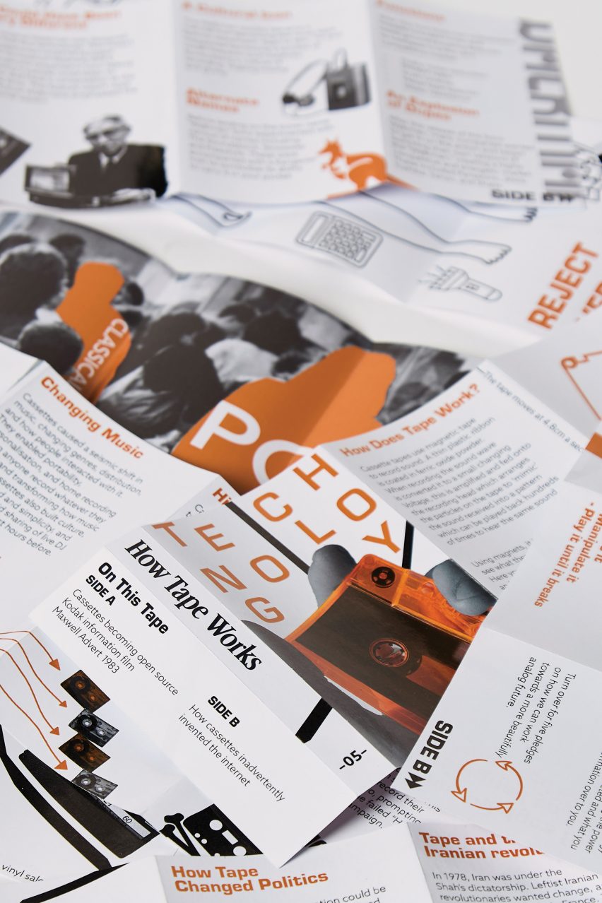 Table strewn with orange and greyscale printed papers