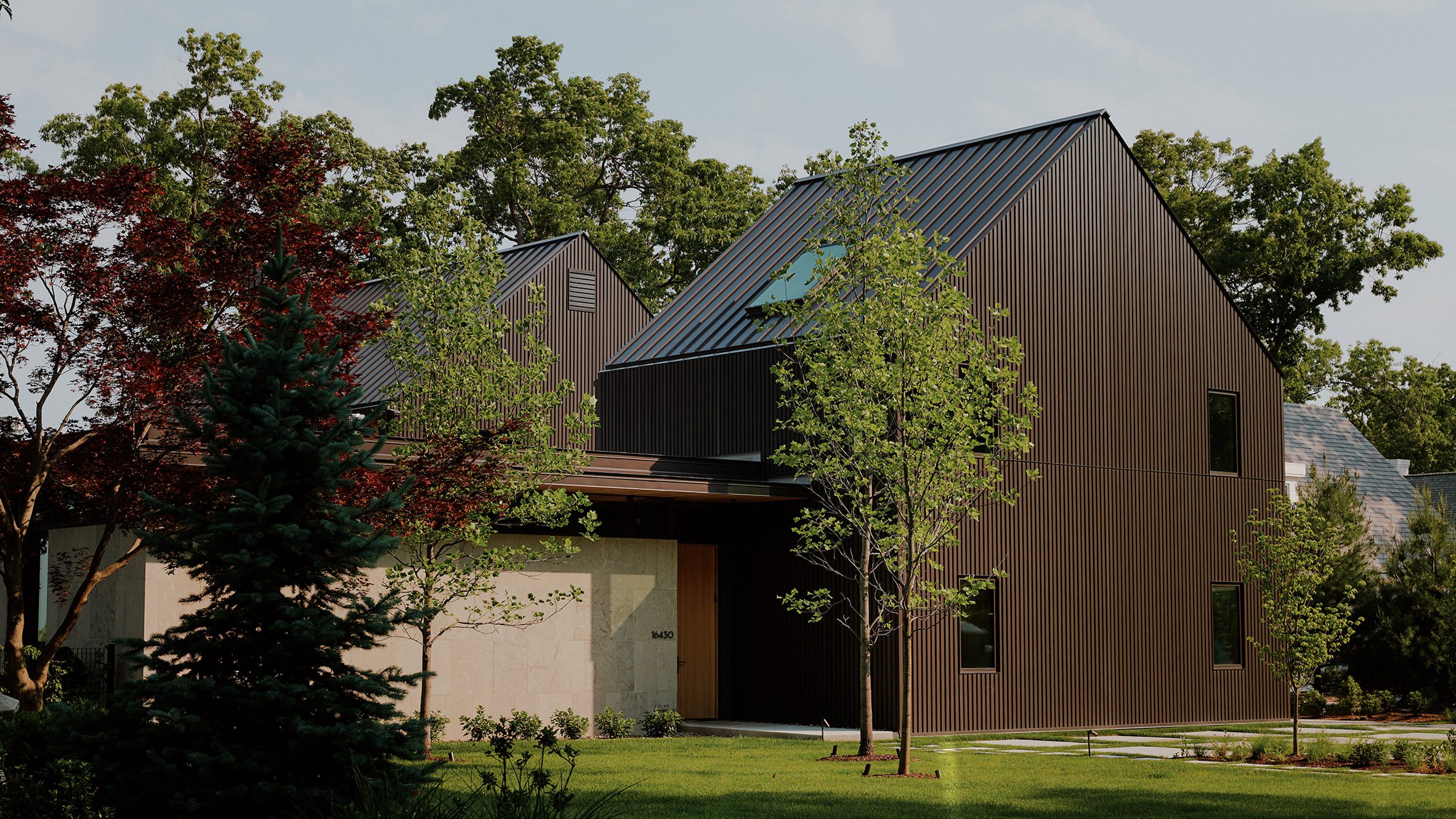 Wheeler Kearns Architects staggers brown-metal house on Lake Michigan shore Read: