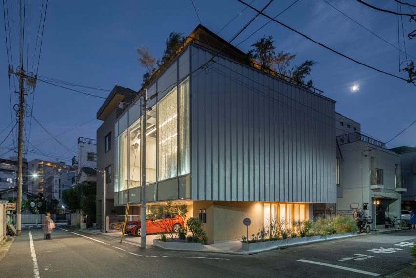 Corner view of Tokyo Ballet House showing the glazed studio on one side and a ribbed expanded polystyrene-clad facade on the other