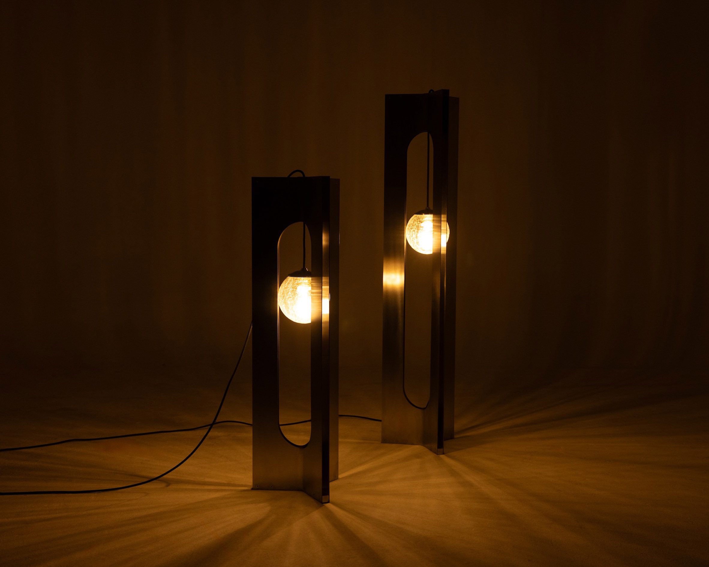Two illuminated lamps in a dark space