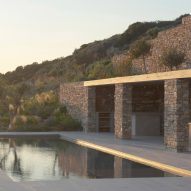 Rough drystone walls frame sunken home on Greek island by Alexandre Pavlidis