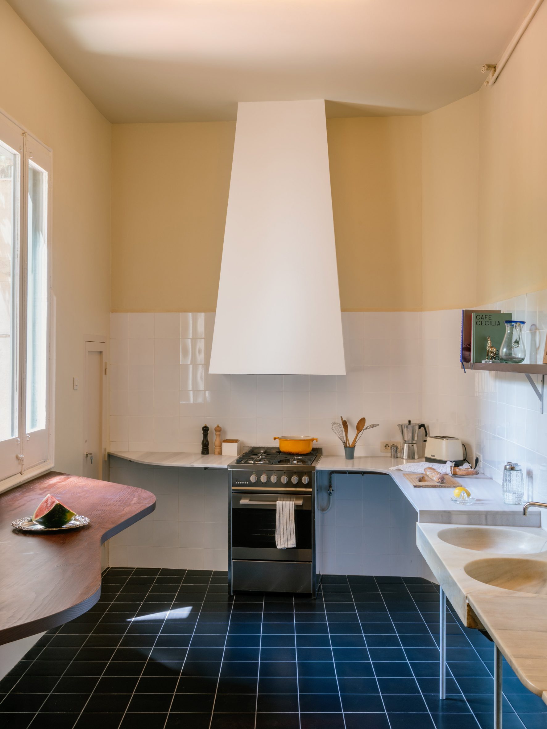 Tile-clad kitchen with a white hood