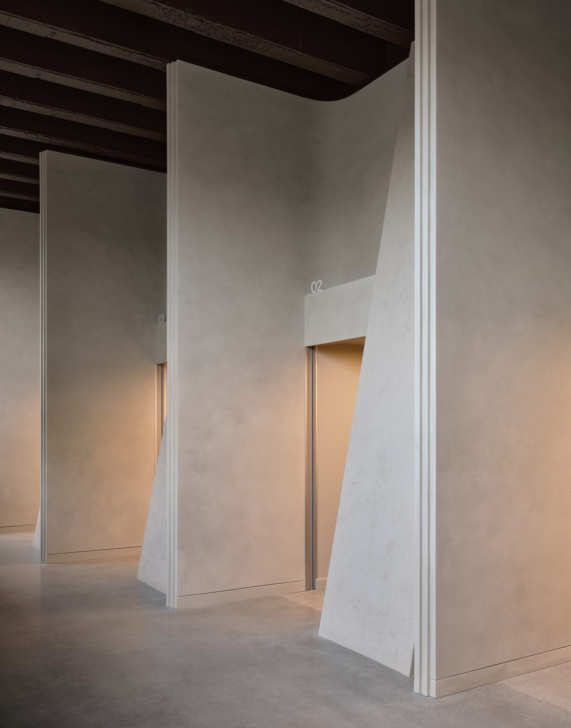 Consultation rooms offset from one another and fronted by sweeping walls