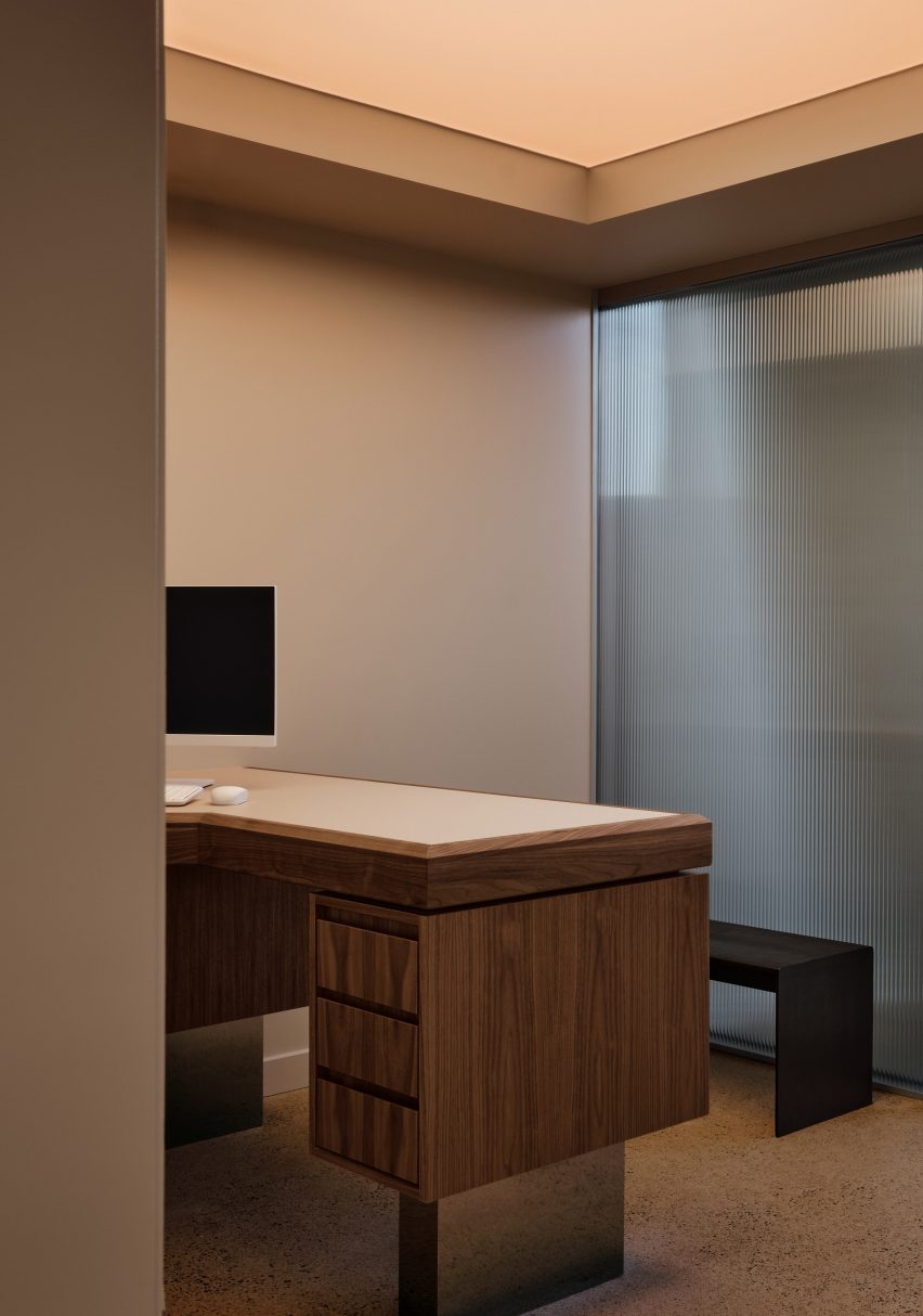 Walnut desk with a chrome base within a consultation room