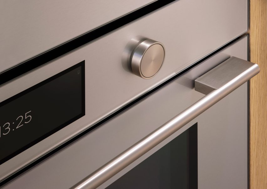 Close-up image of a Fisher & Paykel contemporary oven showing a soft, subtly reflective coloured finish with a precisely machined knob next to a touchscreen