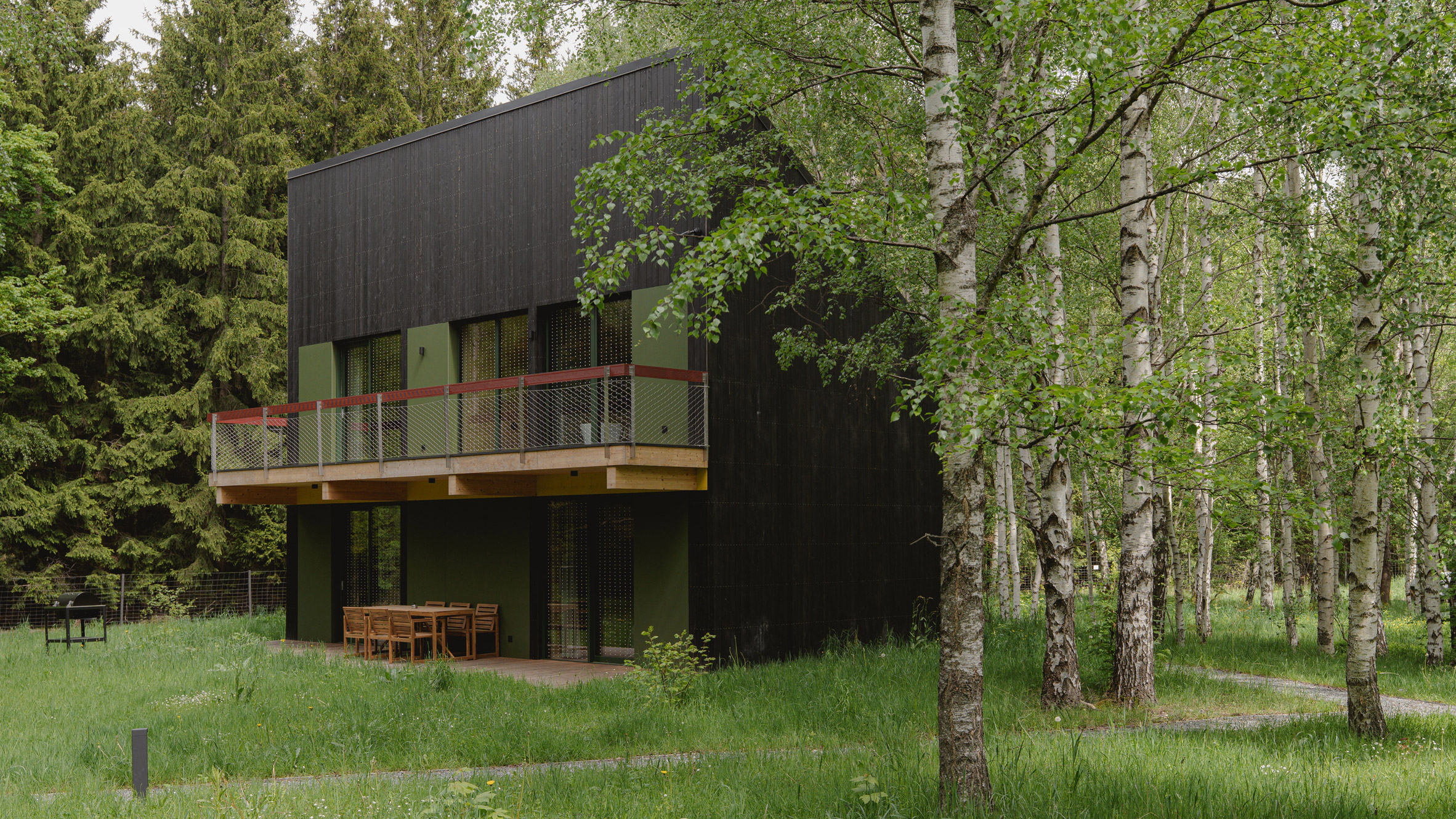 https://static.dezeen.com/uploads/2026/08/kuba-wozniczka-studzienno-27-black-timber-holiday-cabins-poland-hero_dezeen_2364_col_1.jpg