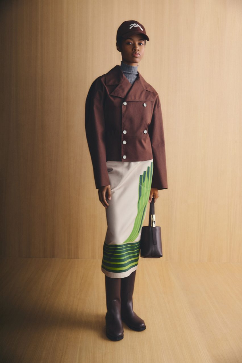 Woman in brown jacket and white skirt