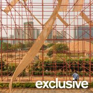 Red scaffolding surrounds temporary pavilion in India