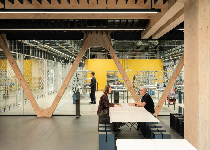 People sitting within timber office by RTA Studio