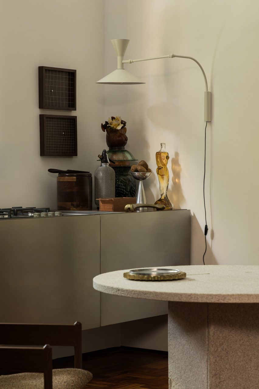 A temporary apartment's kitchen with a counter clad in stainless steel panels