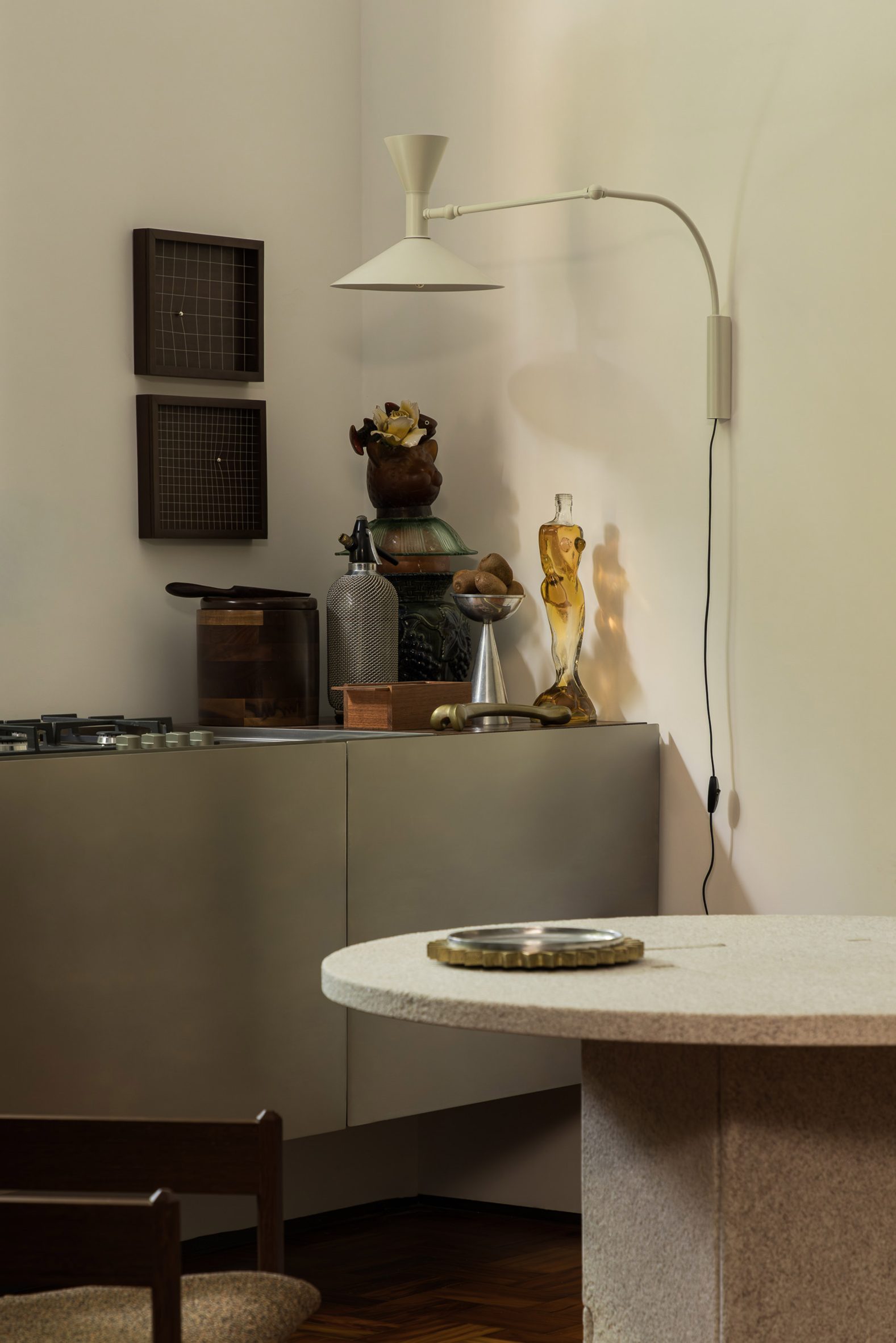 A temporary apartment's kitchen with a counter clad in stainless steel panels