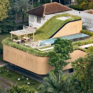 Sloping green roofs "keep the family connected" at Indonesian home
