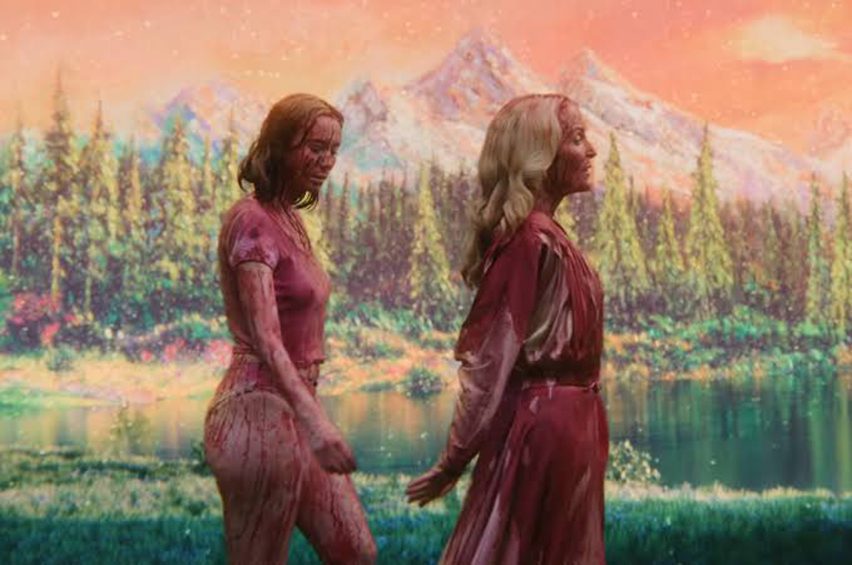 Bloodied women walking hand in hand