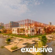 Red scaffolding surrounds temporary pavilion in India