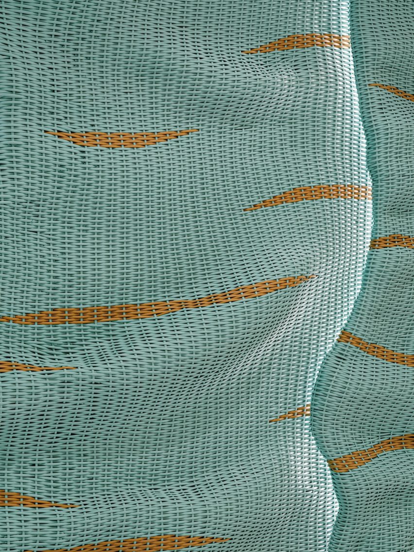 Streaks of tan run horizontally through an undulated blue material