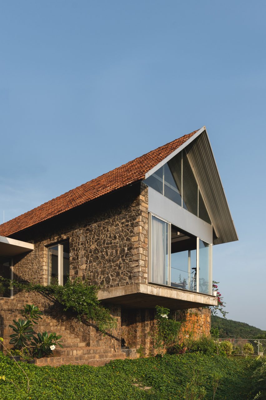 Ushas farmhouse with a pitched tiled roof and cantilevered upper floor