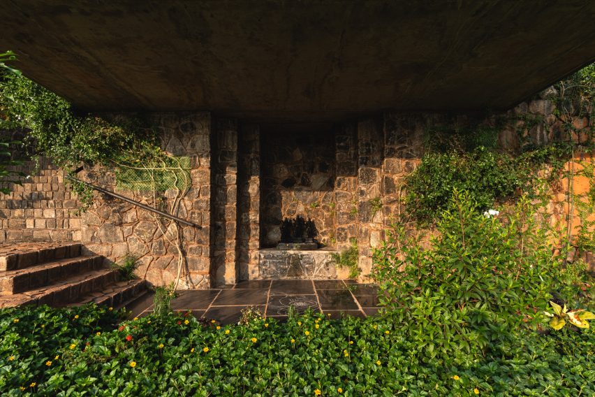 Open-air temple beneath Ushas farmhouse surrounded by planting