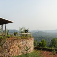 Ushas farmhouse with stone walls overlooking a Kerala hillside