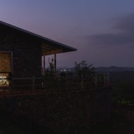 Night view of Ushas farmhouse overlooking hills