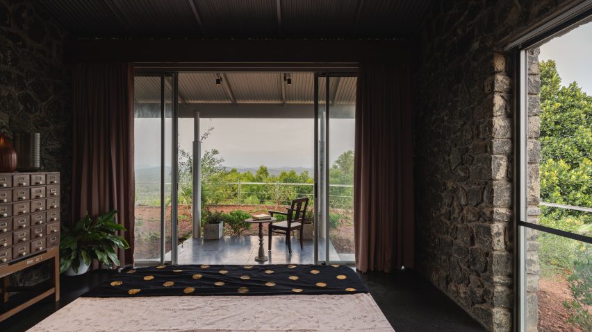 Interior of Ushas farmhouse with stone walls and large glazed doors