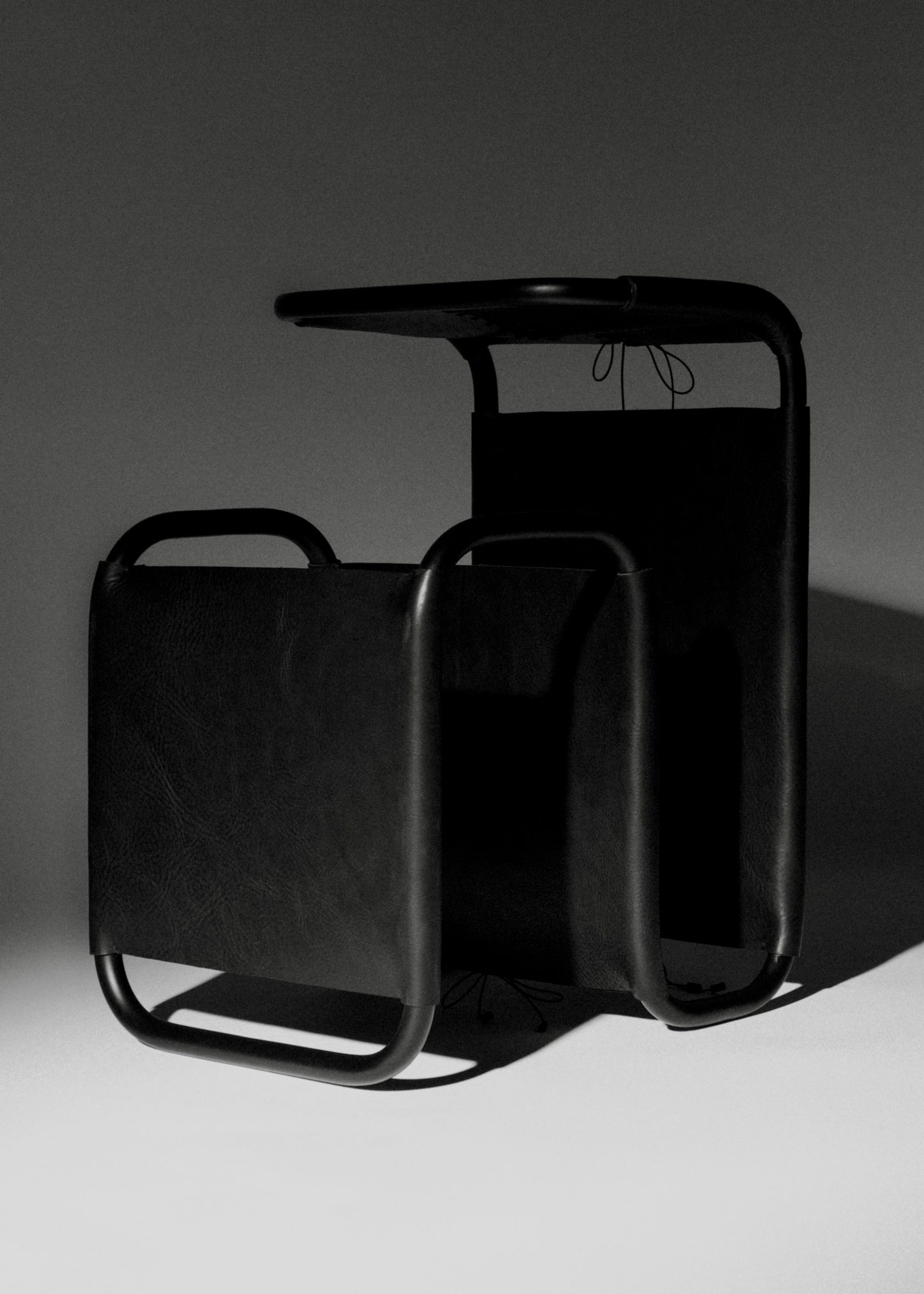 A side table made with a black metal frame. The metal bends back on itself several times. It has taught black leather wrapped around several parts of the frame, tied together with black chord to imitate a corset.