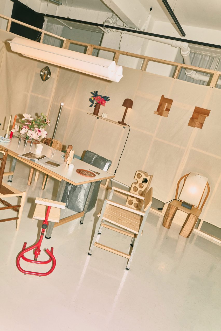 Wooden chairs around a table in With Limitations exhibition