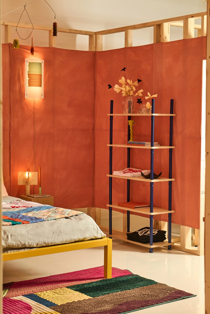 Bed and shelving in a red room